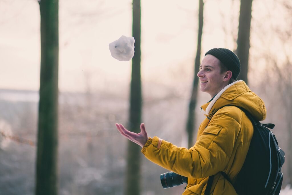 Man holding a snowball showing how time affects compounding